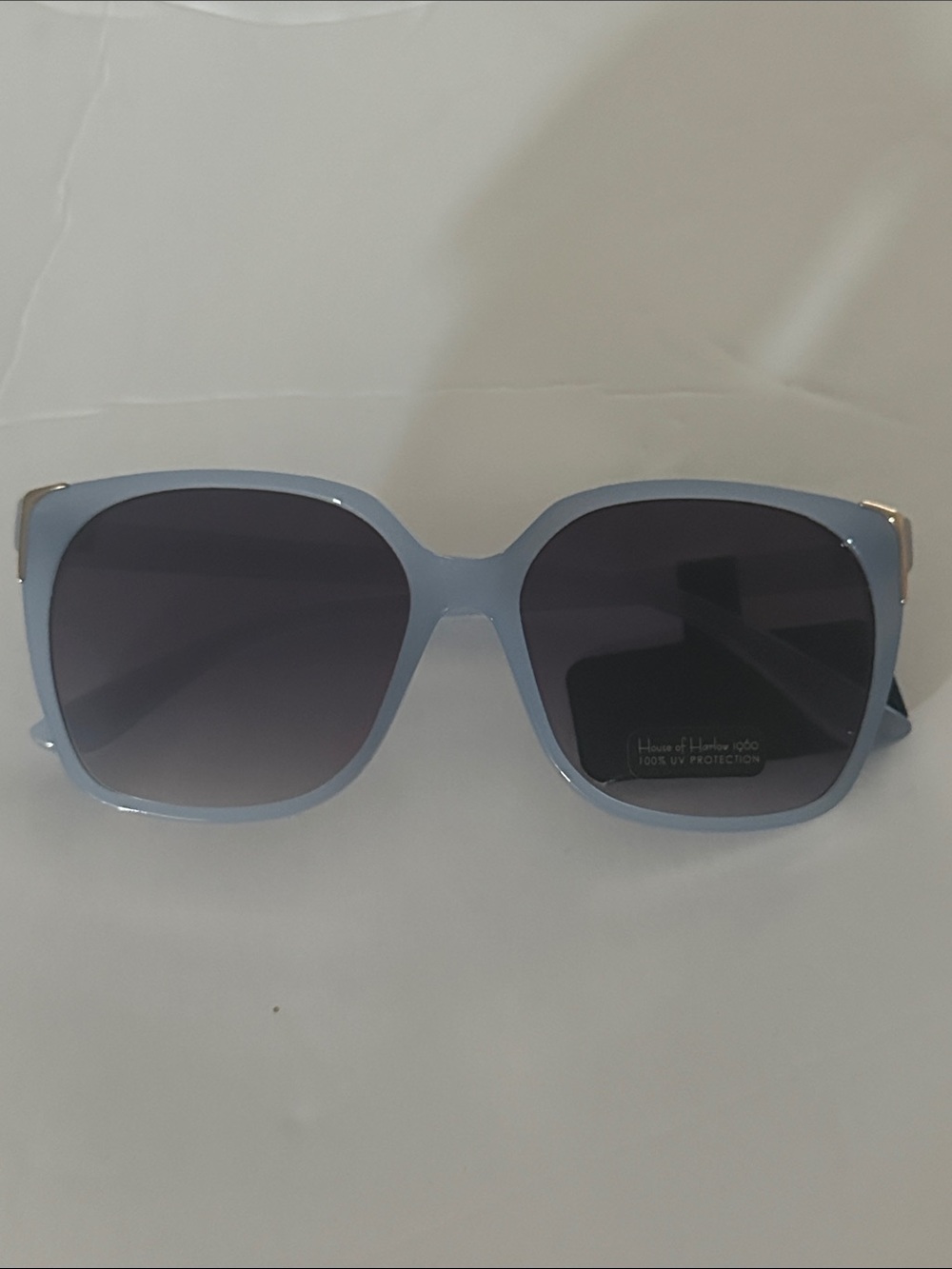 House of Harlow 1960 sunglasses feature light blue square frame gradient lenses